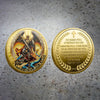 A gold-plated collectible coin featuring the Archangel Michael with wings and a cross design.