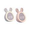 A pair of mini LED cartoon alarm clocks or night lights with light pink bodies and bunny ears displaying 12:30