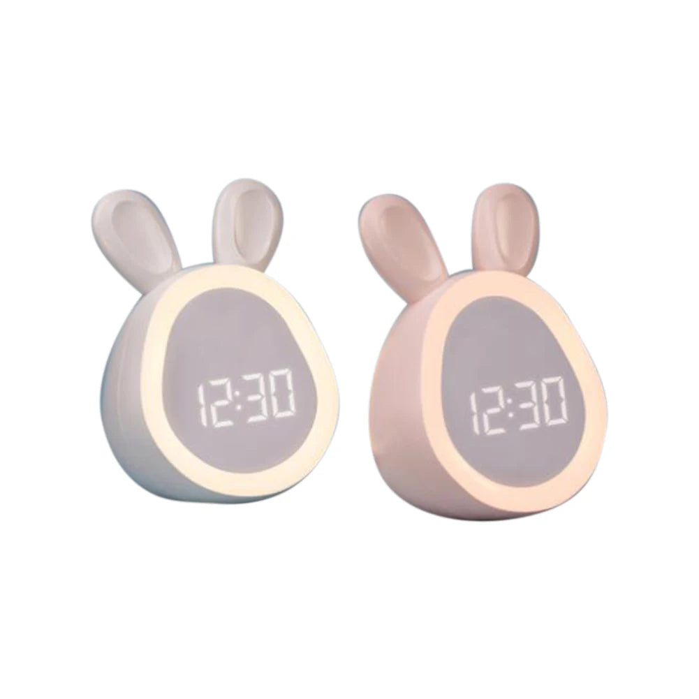 A pair of mini LED cartoon alarm clocks or night lights with light pink bodies and bunny ears displaying 12:30