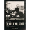 A black and white photo from The Wolf of Wall Street featuring a man in a suit looking down.