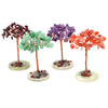 Three natural crystal money trees featuring green, purple, and orange crystals on copper wire stems.