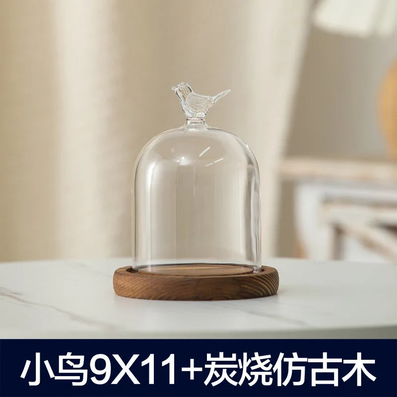 Glass aromatherapy candle holder with a clear dome and a wooden base