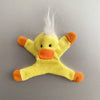 A yellow plush toy shaped like a duck with orange accents and white feathers.