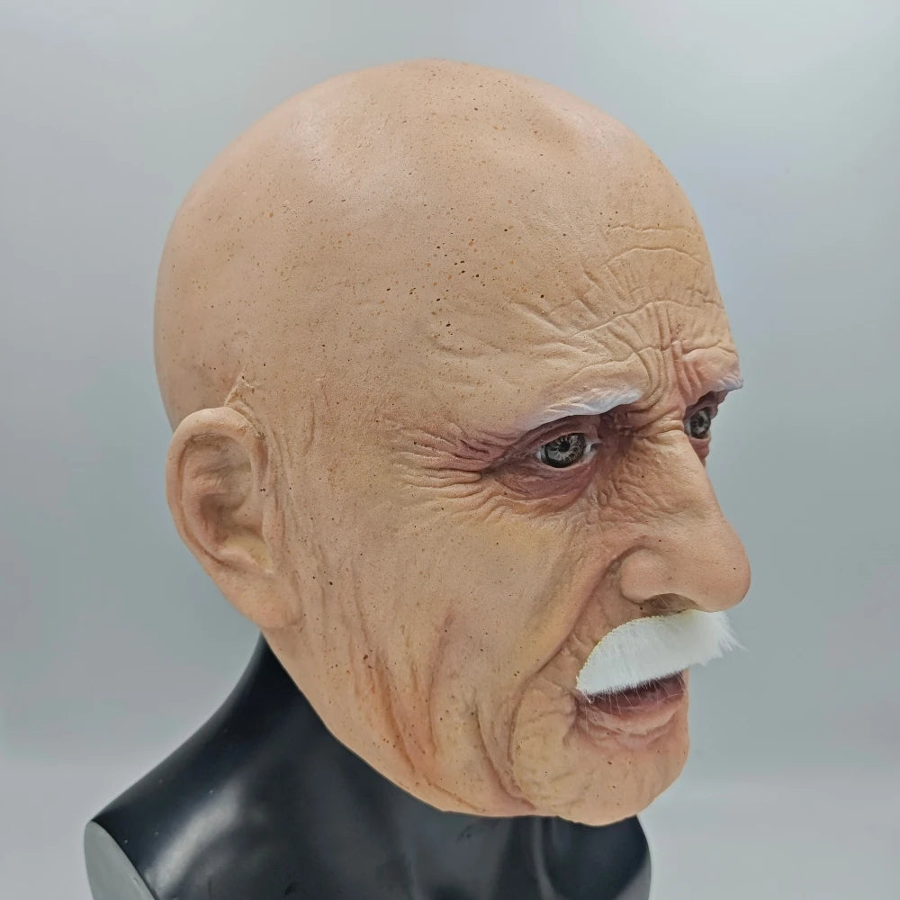 A realistic latex mask of an old man with white hair and a prominent mustache, displayed on a black bust.