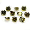A collection of round cut yellow-green cubic zirconia loose stones for jewelry making.