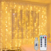 A set of yellow LED curtain lights hanging in a window, with a USB-powered remote control visible.