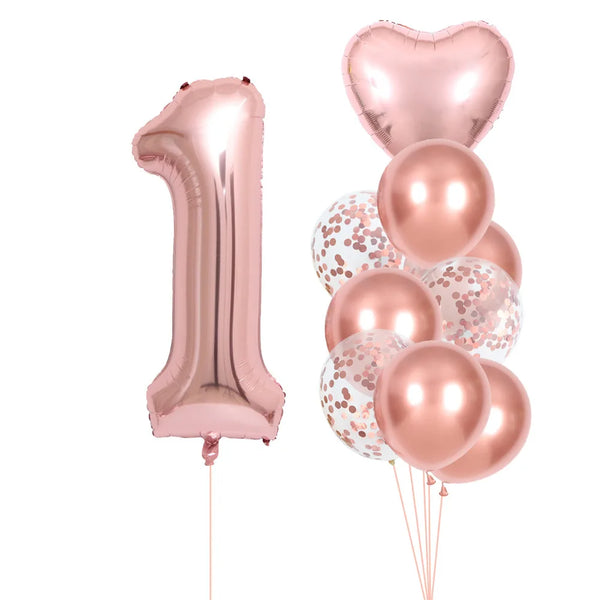 A set of rose gold foil balloons shaped like the number one and several round balloons for party decoration