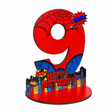 A large red number nine with a spider web design and text that reads Happy Birthday