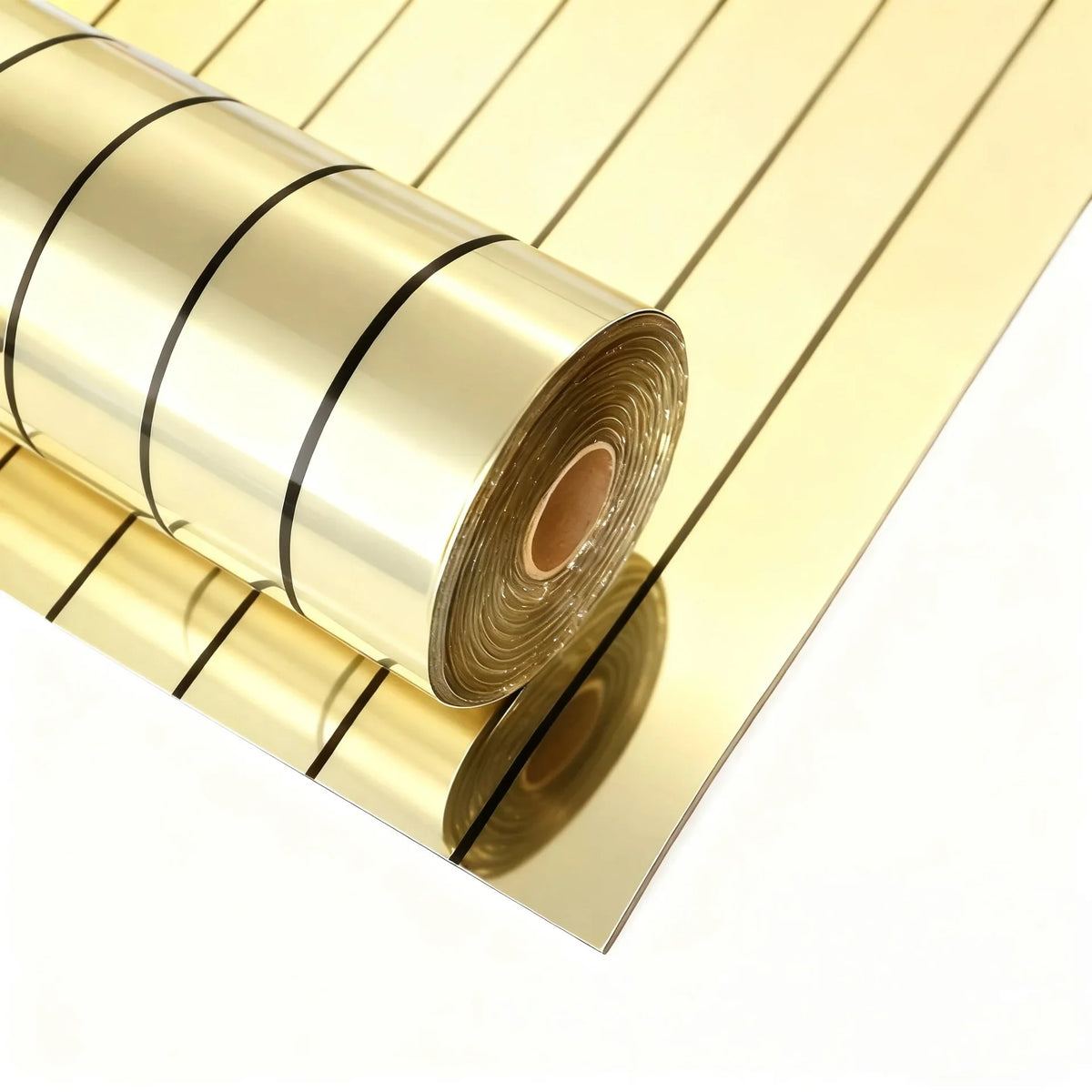 Rolls of gold self-adhesive mirror effect wallpaper stacked diagonally on a white background.