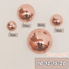 A collection of rose gold disco balls of various sizes, including 10, 12, 15, and 20 cm, displayed on a light background.
