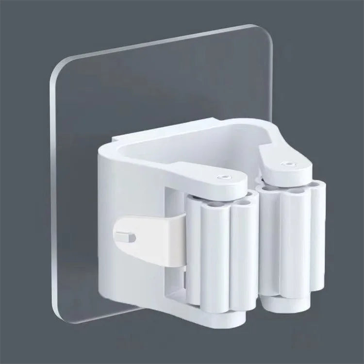 A white adhesive wall hook designed to hold mops and brushes, mounted on a clear acrylic panel.