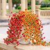 A vibrant arrangement of red and orange silk morning glory vine hanging flowers used for home decor.