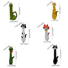 A collection of cat-shaped resin decor items including a green cat vase, a yellow striped cat, and a black cat figure.