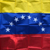 A folded Venezuelan national flag featuring yellow, blue, and red horizontal stripes with white stars.