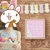 Pink felt letter board with white letters and stand decorated with bunny shapes