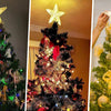 Close-up of a decorated Christmas tree with a glowing star topper and gold ornaments.