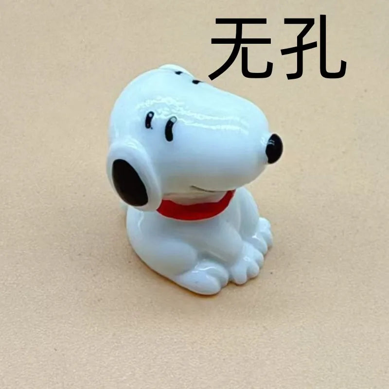 A white ceramic dog pendant with black eyes and a red collar, designed for jewelry making.