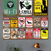A collection of vintage metal signs featuring warnings and messages like Free Wi-Fi, I Smoke I Chill, and Connectada 24H Secu