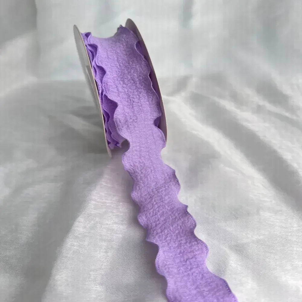 Purple decorative fishtail yarn ribbon displayed against a white background.