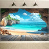 A framed photograph of a tropical beach with turquoise water, white sand, and rock formations viewed through a natural cave o