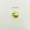 A round, gold mosaic disco ball decor mounted on a white surface, with a 10cm/4in scale marker.