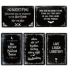 Three black metal tin signs featuring gothic and spooky Halloween phrases like No Soliciting and Live Laugh Lobotomy