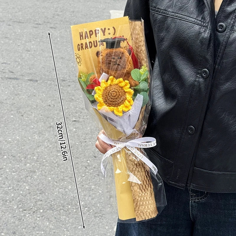 A bouquet of handcrafted crochet flowers and a teddy bear wrapped in yellow paper held by a person.