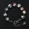 A charm bracelet featuring three enamel charms of Itadori, Fushiguro, and Gojo from Jujutsu Kaisen set against a dark backgro