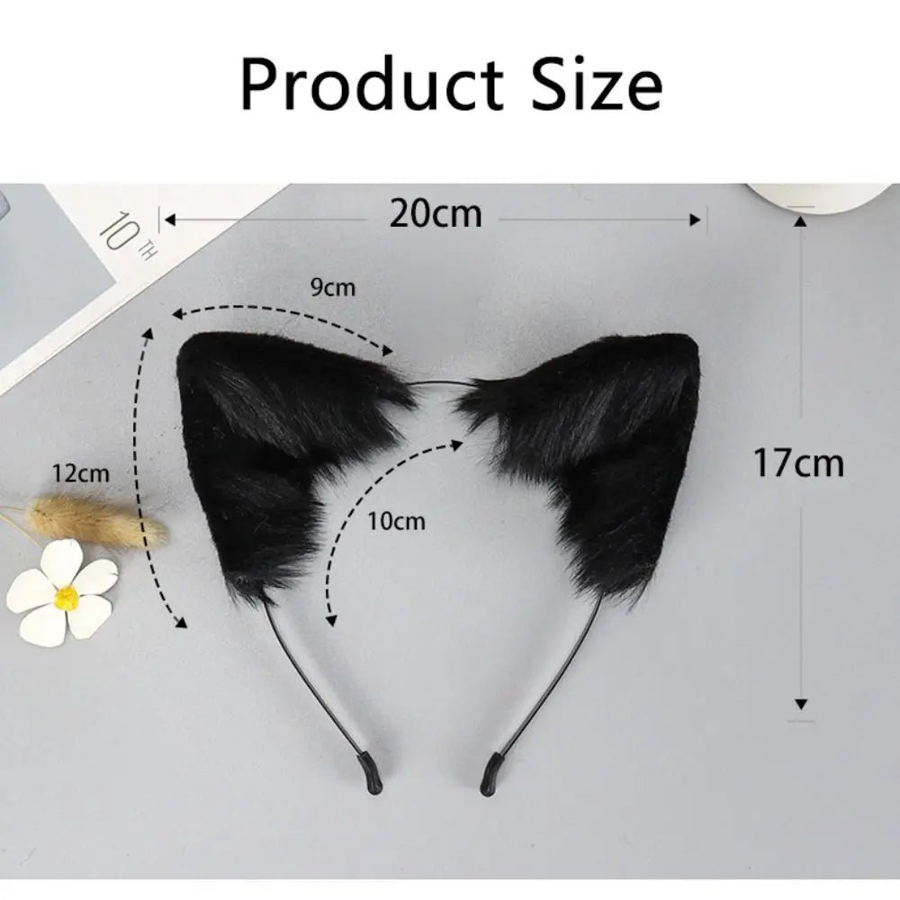A pair of black plush fox ears with long strings displayed on a light gray surface.