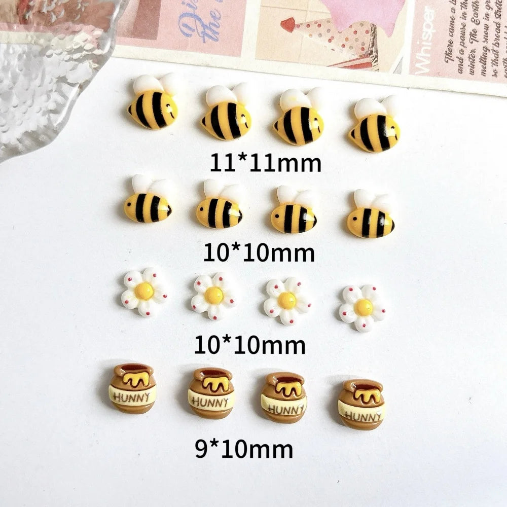 A collection of cute bee and daisy 3D resin nail art charms in various sizes and colors.