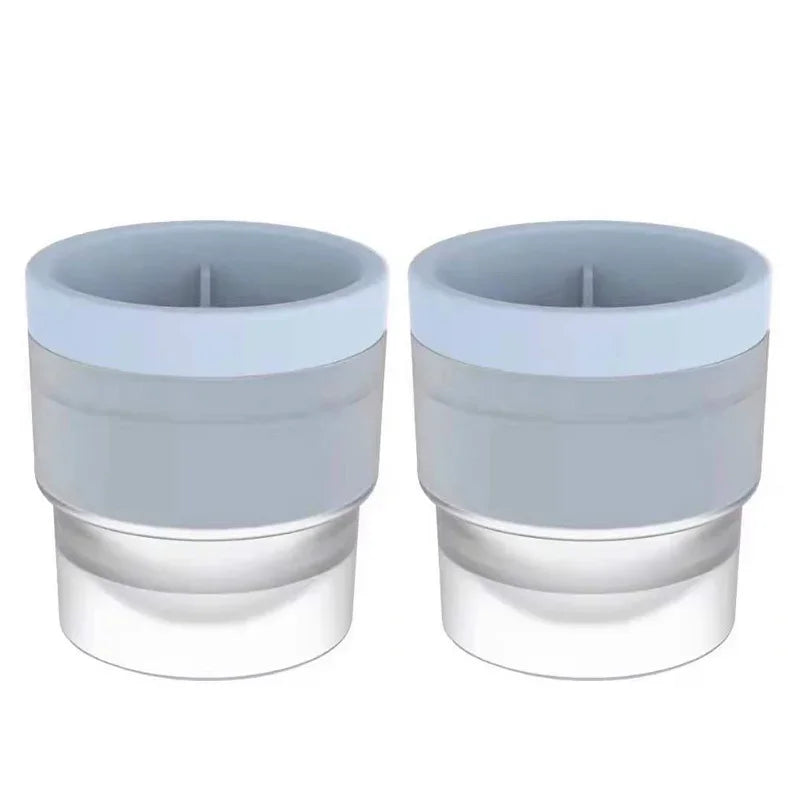 A pair of stackable spherical ice molds for whiskey and cocktails, shown in light gray.