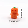 An orange 3D printed cartoon animal figurine resembling a small, round bear or creature.
