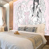 Dormitorio con cama de ropa de cama blanca y cojines contra un tapiz de chica anime rosa.