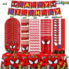 A set of red and black superhero themed party tableware including banners, plates, cups, and napkins.