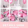 A collection of pink and silver heart-shaped foil balloons displayed on a white surface.