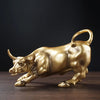 A golden sculpture of a bull in profile against a dark background.