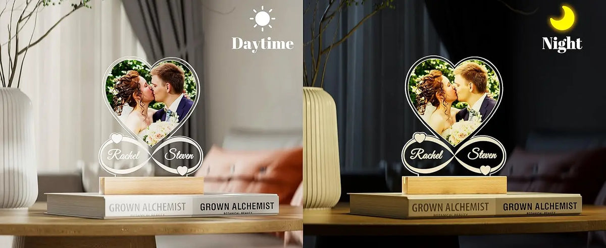 A pair of personalized acrylic photo frames engraved with names Rachel and Steven, displayed next to a daytime and night ligh