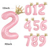 Pink foil crown number balloons spelling out 012 and 456789