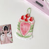 A pink and green cartoon strawberry bag keychain card holder with a heart design and red fruit accents.