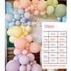 A collection of pink, yellow, purple, blue, and green balloons arranged in a garland display.