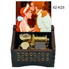 A wooden music box featuring an illustration of a couple and an antique music box mechanism.