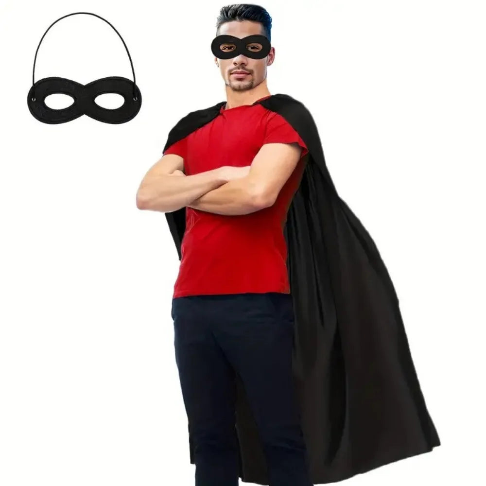 A man wearing a red shirt and black eye mask with a flowing black cape.