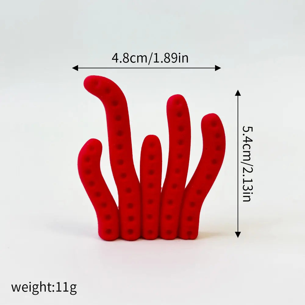 A set of three red ocean animal cake toppers: a whale, an octopus, and a turtle.