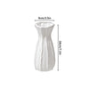 Modern white plastic decorative vase with vertical ribbed texture.