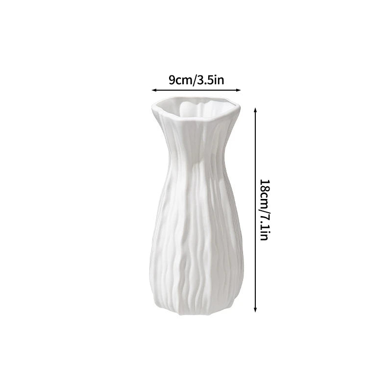 Modern white plastic decorative vase with vertical ribbed texture.