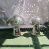 Two mushroom-shaped mirror disco ball decorations are displayed against a white background with light patterns.