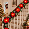 An LED poinsettia garland with warm white lights decorates a staircase for Christmas holiday display.