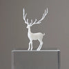 A white resin ornament of an elk deer with antlers standing on a clear glass block.