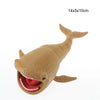 A tan, articulated sea monster fidget toy with an open mouth showing red gums and teeth.