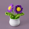 Hand woven crochet purple and yellow flowers in a white pot